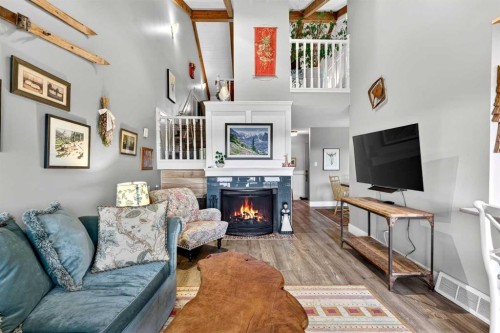 832-860 Midridge Drive Se, Calgary, AB - Indoor Photo Showing Living Room With Fireplace