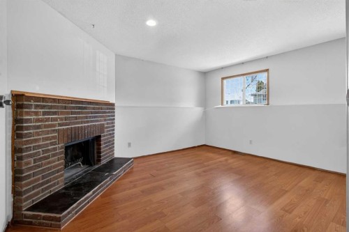 123 Rundleridge Way Ne, Calgary, AB - Indoor Photo Showing Other Room With Fireplace