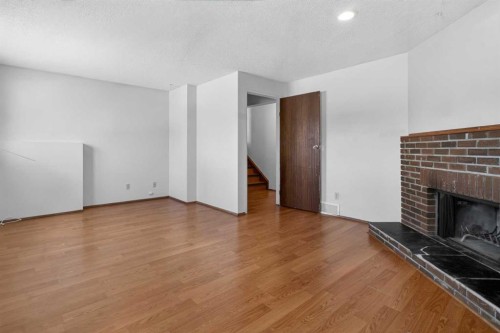 123 Rundleridge Way Ne, Calgary, AB - Indoor Photo Showing Other Room With Fireplace