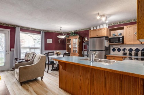 102 Cimarron Trail, Okotoks, AB - Indoor Photo Showing Kitchen With Double Sink