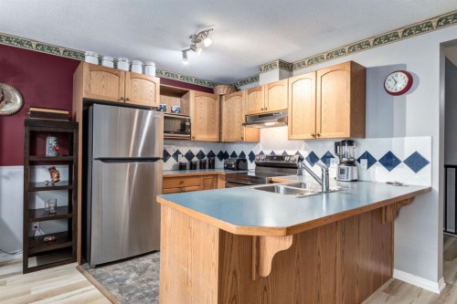 102 Cimarron Trail, Okotoks, AB - Indoor Photo Showing Kitchen With Double Sink