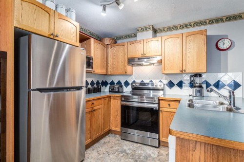 102 Cimarron Trail, Okotoks, AB - Indoor Photo Showing Kitchen With Double Sink