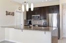 408-207 Sunset Drive, Cochrane, AB  - Indoor Photo Showing Kitchen With Stainless Steel Kitchen With Upgraded Kitchen 