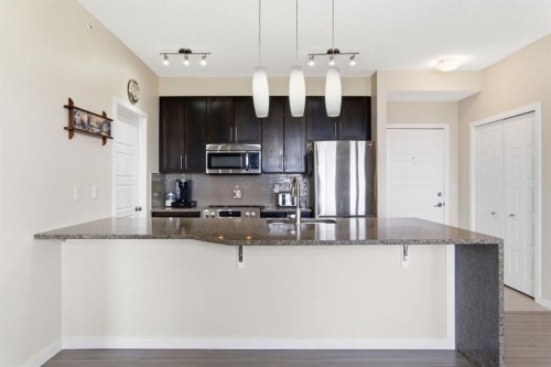 408-207 Sunset Drive, Cochrane, AB - Indoor Photo Showing Kitchen With Stainless Steel Kitchen With Upgraded Kitchen
