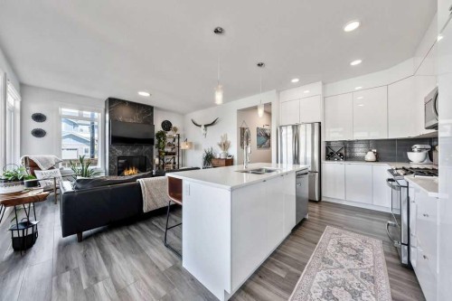 29 Sundown Close, Cochrane, AB - Indoor Photo Showing Kitchen With Fireplace With Upgraded Kitchen