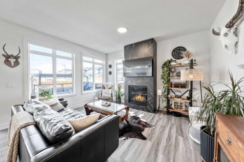 29 Sundown Close, Cochrane, AB - Indoor Photo Showing Living Room With Fireplace
