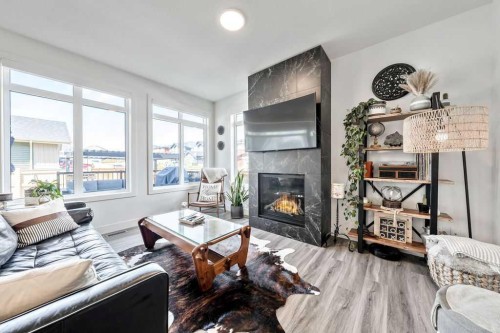 29 Sundown Close, Cochrane, AB - Indoor Photo Showing Living Room With Fireplace