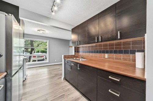 23-6915 Ranchview Drive Nw, Calgary, AB - Indoor Photo Showing Kitchen With Double Sink