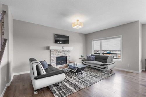247 Hillcrest Heights Sw, Airdrie, AB - Indoor Photo Showing Living Room With Fireplace