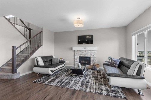 247 Hillcrest Heights Sw, Airdrie, AB - Indoor Photo Showing Living Room With Fireplace