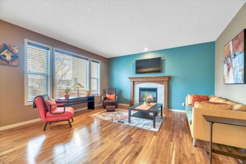 8 Sunset Square, Cochrane, AB - Indoor Photo Showing Living Room With Fireplace