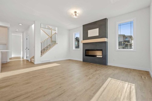 571 Buffaloberry Manor Se, Calgary, AB - Indoor Photo Showing Living Room With Fireplace