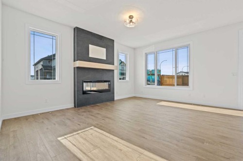571 Buffaloberry Manor Se, Calgary, AB - Indoor Photo Showing Living Room With Fireplace