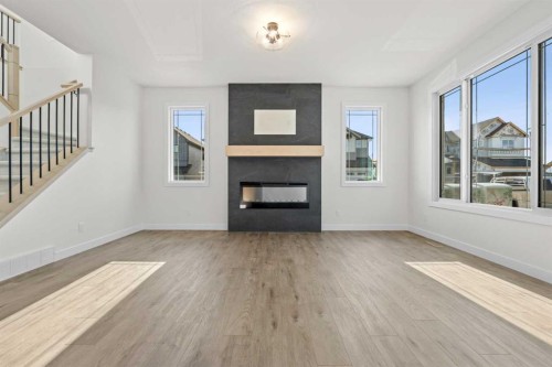 571 Buffaloberry Manor Se, Calgary, AB - Indoor Photo Showing Living Room With Fireplace