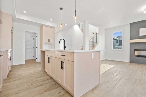 571 Buffaloberry Manor Se, Calgary, AB - Indoor Photo Showing Kitchen With Fireplace