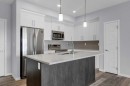 323-4150 Seton Drive Se, Calgary, AB  - Indoor Photo Showing Kitchen With Stainless Steel Kitchen With Double Sink With Upgraded Kitchen 