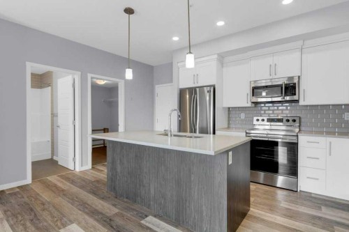 323-4150 Seton Drive Se, Calgary, AB - Indoor Photo Showing Kitchen With Stainless Steel Kitchen With Upgraded Kitchen