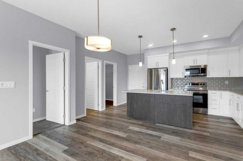 323-4150 Seton Drive Se, Calgary, AB - Indoor Photo Showing Kitchen With Stainless Steel Kitchen With Upgraded Kitchen