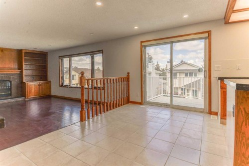 393 Hawktree Circle Nw, Calgary, AB - Indoor With Fireplace