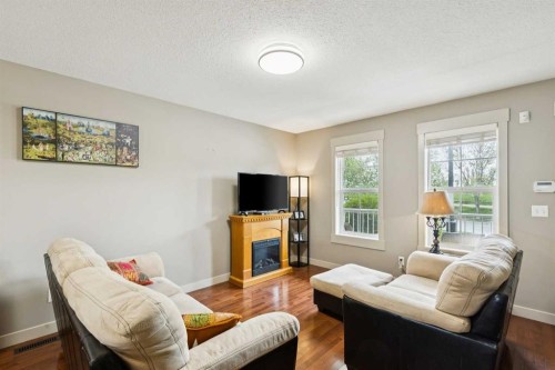 248 Cascades Pass, Chestermere, AB - Indoor Photo Showing Living Room With Fireplace