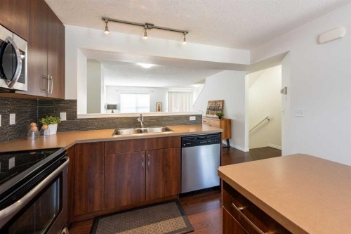 38 Cranford Drive Se, Calgary, AB - Indoor Photo Showing Kitchen With Stainless Steel Kitchen With Double Sink