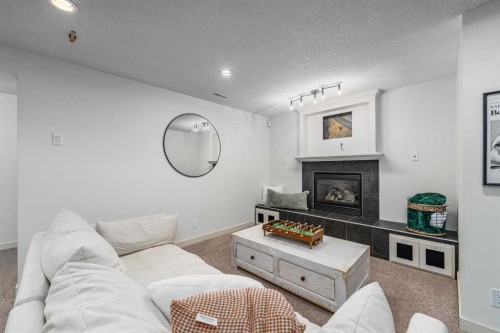 77 Everbrook Drive Sw, Calgary, AB - Indoor Photo Showing Living Room With Fireplace