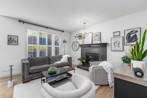 77 Everbrook Drive Sw, Calgary, AB - Indoor Photo Showing Living Room With Fireplace