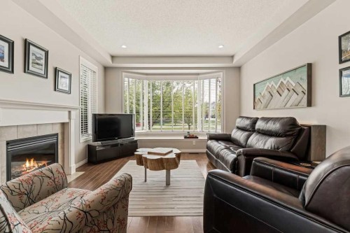 728 Windridge Road Sw, Airdrie, AB - Indoor Photo Showing Living Room With Fireplace