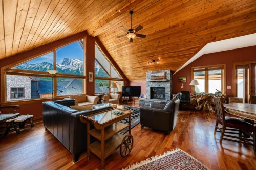 403-505 Spring Creek Drive, Canmore, AB - Indoor Photo Showing Living Room With Fireplace