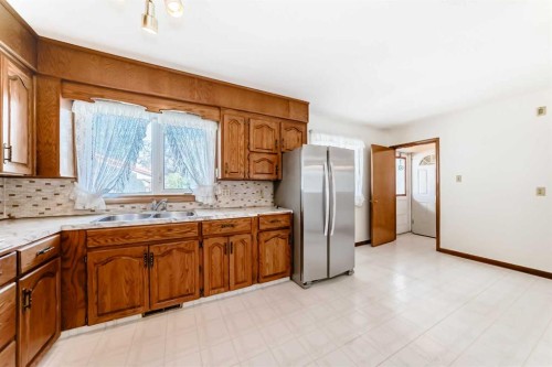 54 Fullerton Road Se, Calgary, AB - Indoor Photo Showing Kitchen With Double Sink