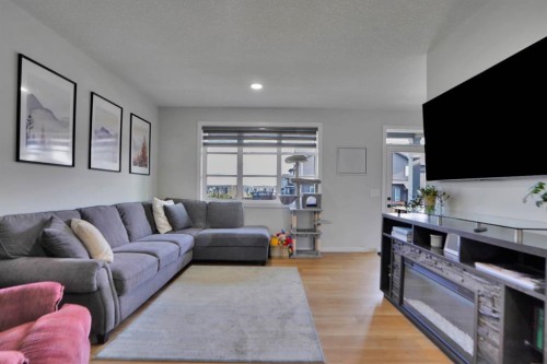 112 Langwell Common Se, Airdrie, AB - Indoor Photo Showing Living Room With Fireplace