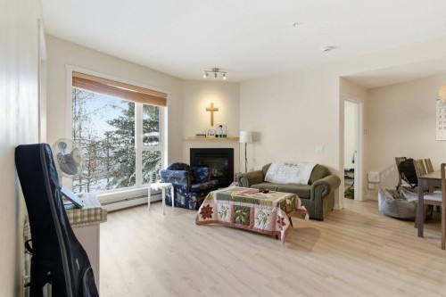 210-69 Springborough Court Sw, Calgary, AB - Indoor Photo Showing Living Room With Fireplace