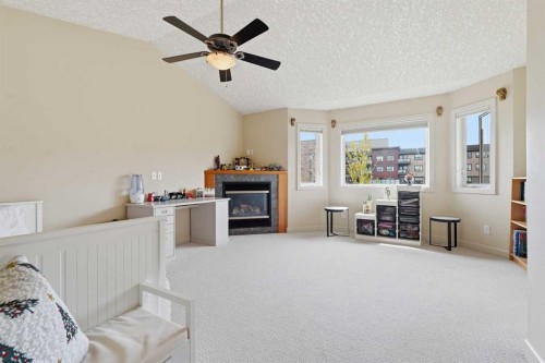 37 Prominence Park Sw, Calgary, AB - Indoor With Fireplace
