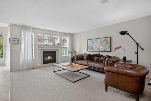 98 Cougarstone Close Sw, Calgary, AB - Indoor Photo Showing Living Room With Fireplace