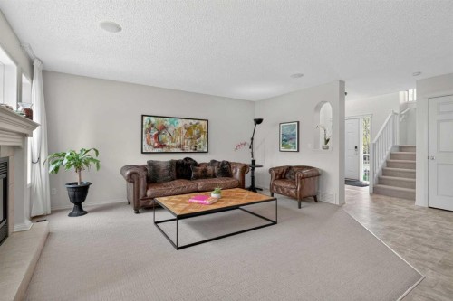 98 Cougarstone Close Sw, Calgary, AB - Indoor Photo Showing Living Room With Fireplace