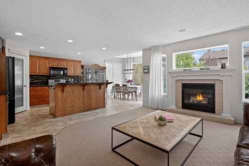 98 Cougarstone Close Sw, Calgary, AB - Indoor Photo Showing Living Room With Fireplace