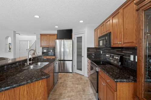 98 Cougarstone Close Sw, Calgary, AB - Indoor Photo Showing Kitchen With Stainless Steel Kitchen With Double Sink