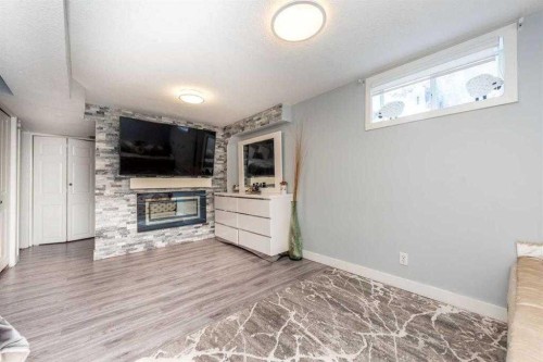 23 Falsby Place Ne, Calgary, AB - Indoor With Fireplace