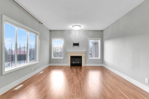 197 Royal Crest View Nw, Calgary, AB - Indoor Photo Showing Living Room With Fireplace