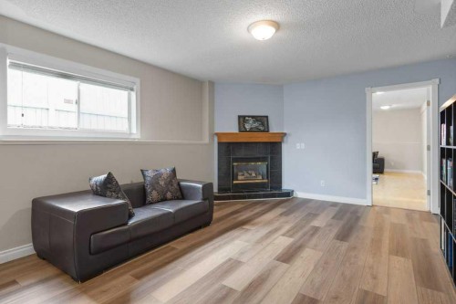 202 Willowbrook Close Nw, Airdrie, AB - Indoor Photo Showing Living Room With Fireplace