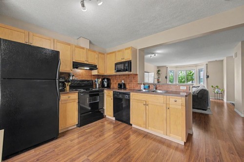 65 Royal Birch Villas Nw, Calgary, AB - Indoor Photo Showing Kitchen With Double Sink