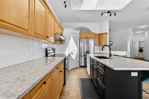 18 Eagleview Place, Cochrane, AB - Indoor Photo Showing Kitchen With Upgraded Kitchen