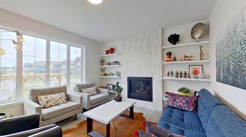 168 Magnolia Manor Se, Calgary, AB - Indoor Photo Showing Living Room With Fireplace