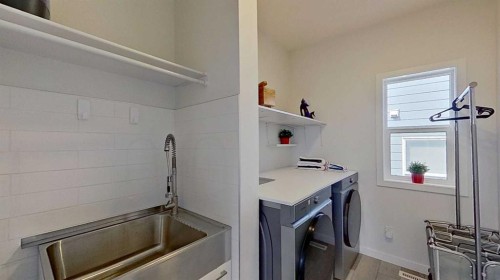 168 Magnolia Manor Se, Calgary, AB - Indoor Photo Showing Laundry Room
