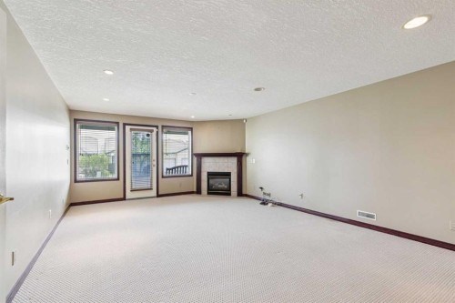 14 Strathearn Gardens Sw, Calgary, AB - Indoor Photo Showing Other Room With Fireplace
