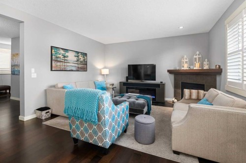 124 Evergreen Circle Sw, Calgary, AB - Indoor Photo Showing Living Room With Fireplace