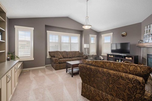 124 Evergreen Circle Sw, Calgary, AB - Indoor Photo Showing Living Room With Fireplace