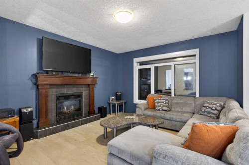 9 Westridge Way, Okotoks, AB - Indoor Photo Showing Living Room With Fireplace