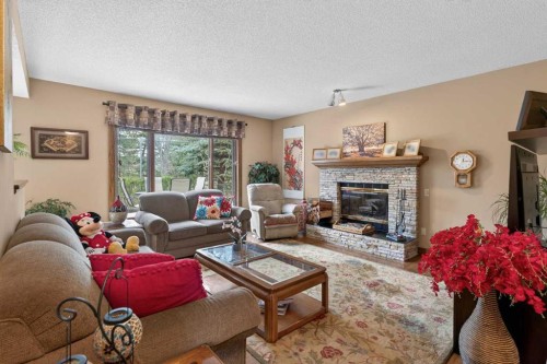 935 Shawnee Drive Sw, Calgary, AB - Indoor Photo Showing Living Room With Fireplace