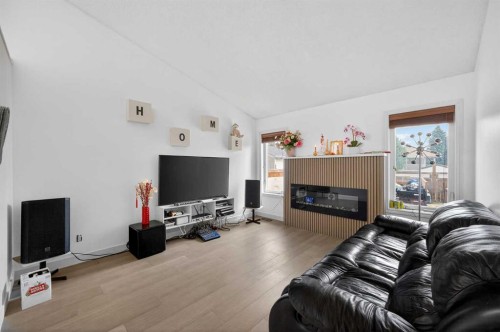 35 Erin Green Place Se, Calgary, AB - Indoor Photo Showing Living Room With Fireplace